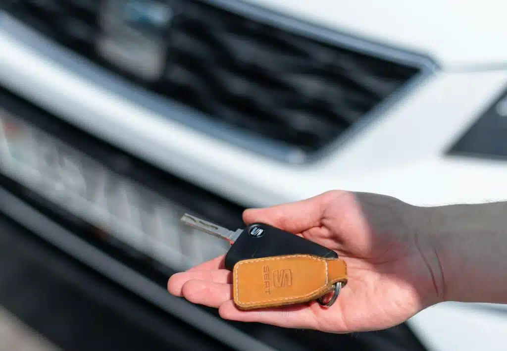 A person holding car keys in their hand