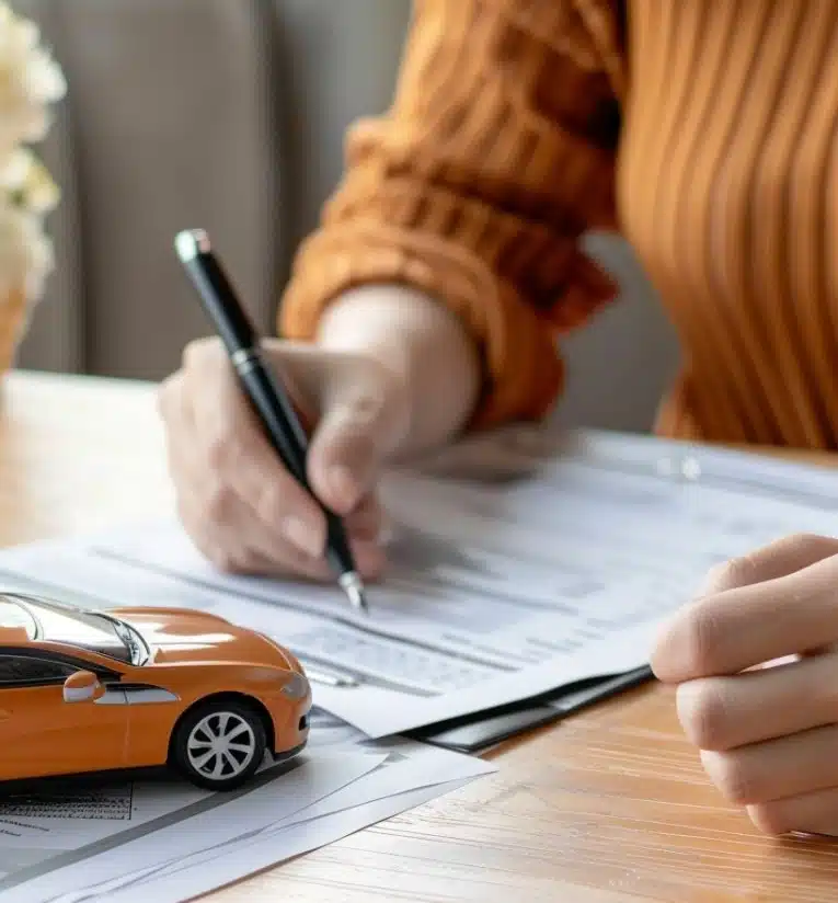 A woman signing a document on a table