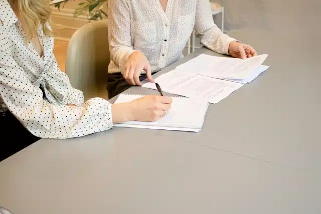 A woman filling out car title pawn paperwork. 