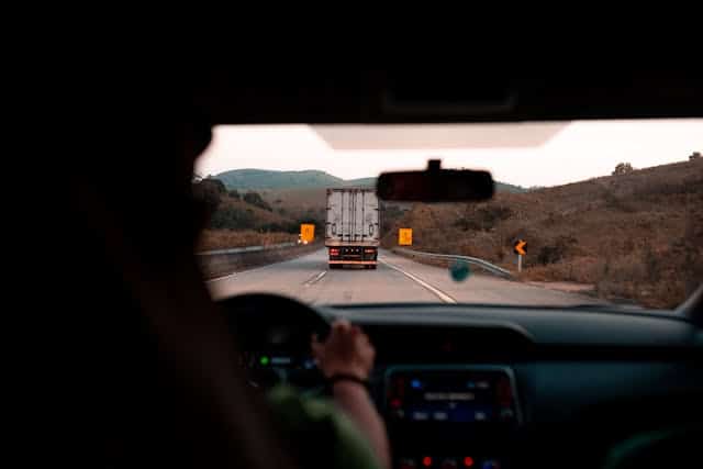 A person driving a vehicle, representing the ability to retain car use during a title pawn repayment period. 